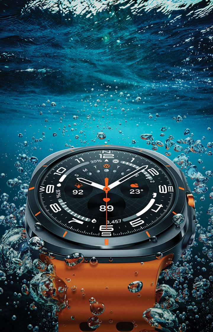 A Galaxy Watch7 with a watch face showing heart rate, steps and other workout metrics is slightly tilted facing top left. A text 'Galaxy AI is here' with a Galaxy AI icon can be seen.