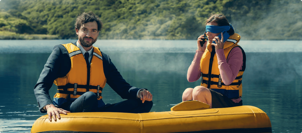 two people sitting in an inflatable dingy on a lake