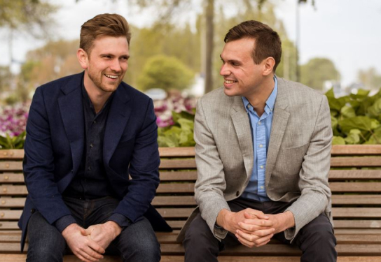 Image of two men sitting on a park bench