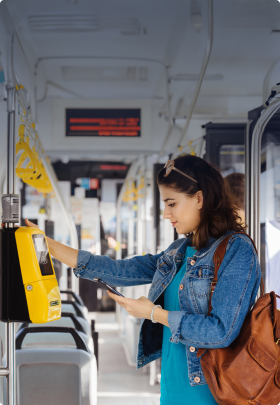 Image of a woman on her mobile phone getting onto a bus