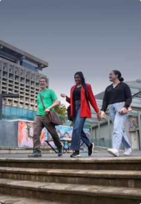 Photo of students leaving a university building and walking down stairs