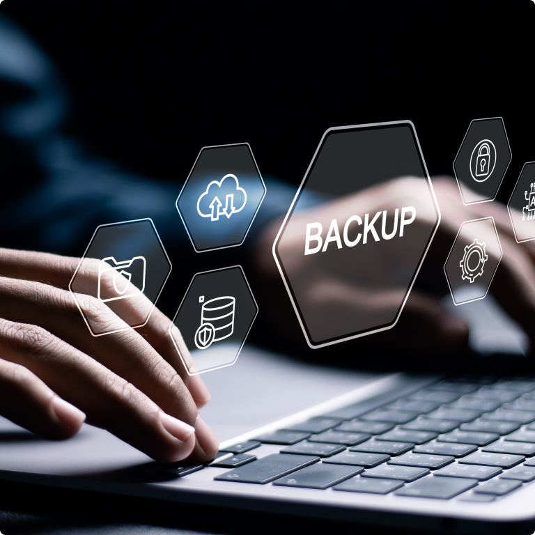 Image of a laptop keyboard with fingers typing and an overlay of hexagon shapes with the word "Backup"