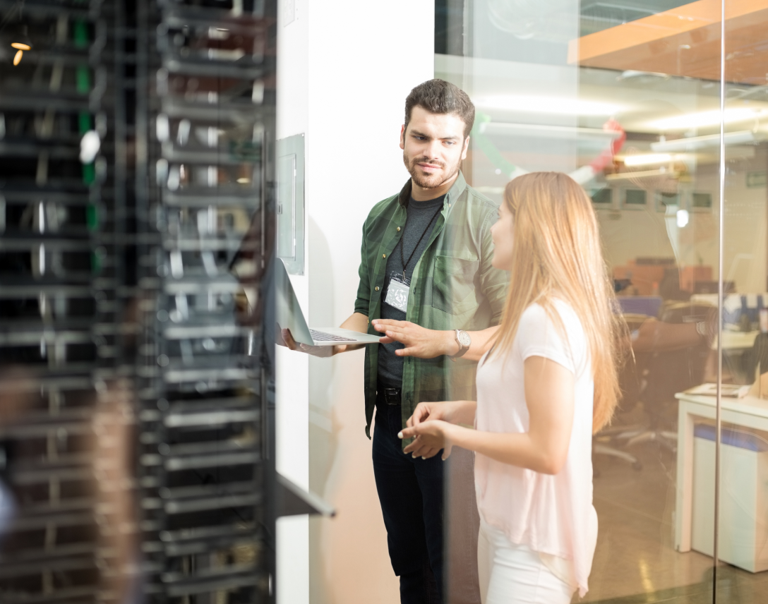 Colleagues talking in office server room