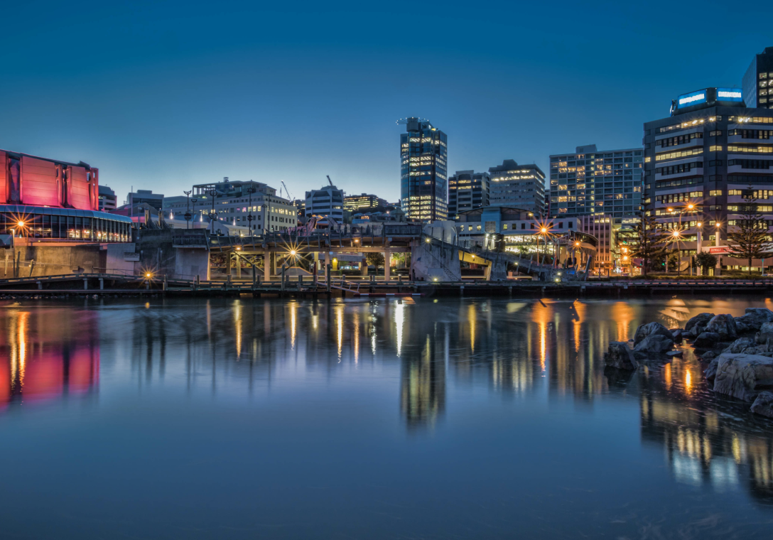 Image of the waterfront and the Wellington skyline at night with lights on in the office buildings