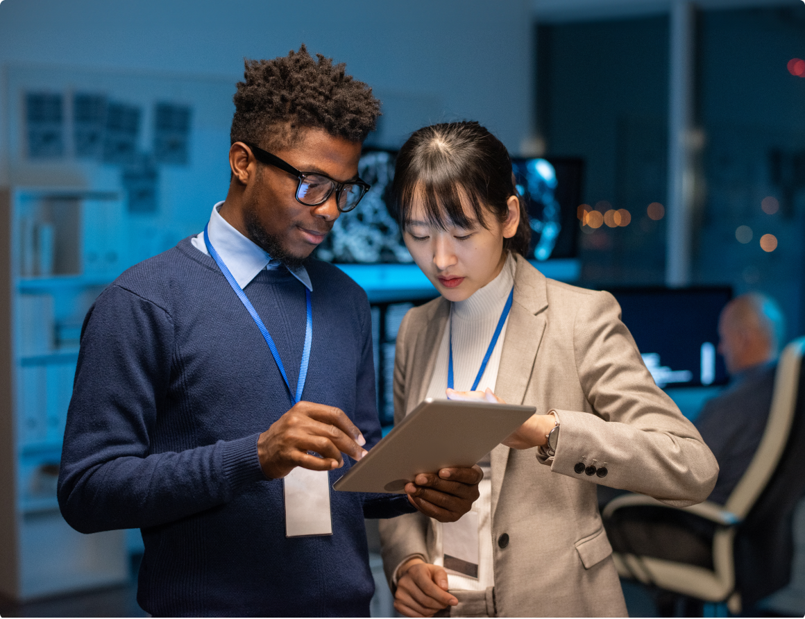 Two colleagues scrolling on a tablet