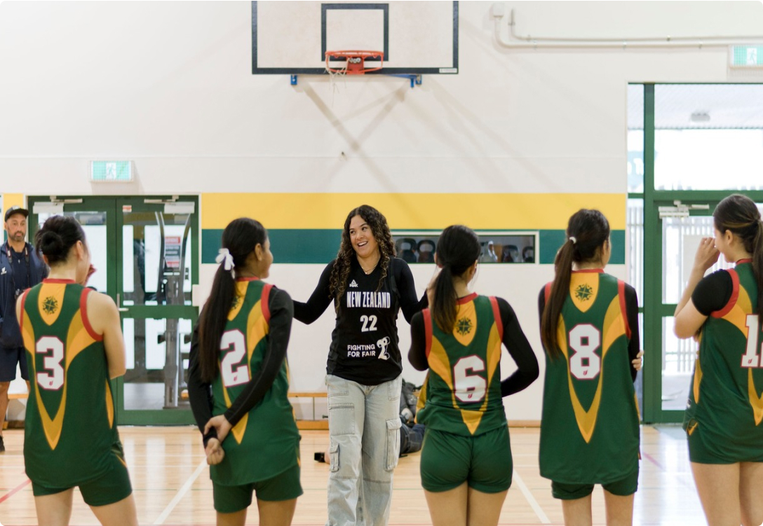 Photo of a Woman coaching a girls basketball team