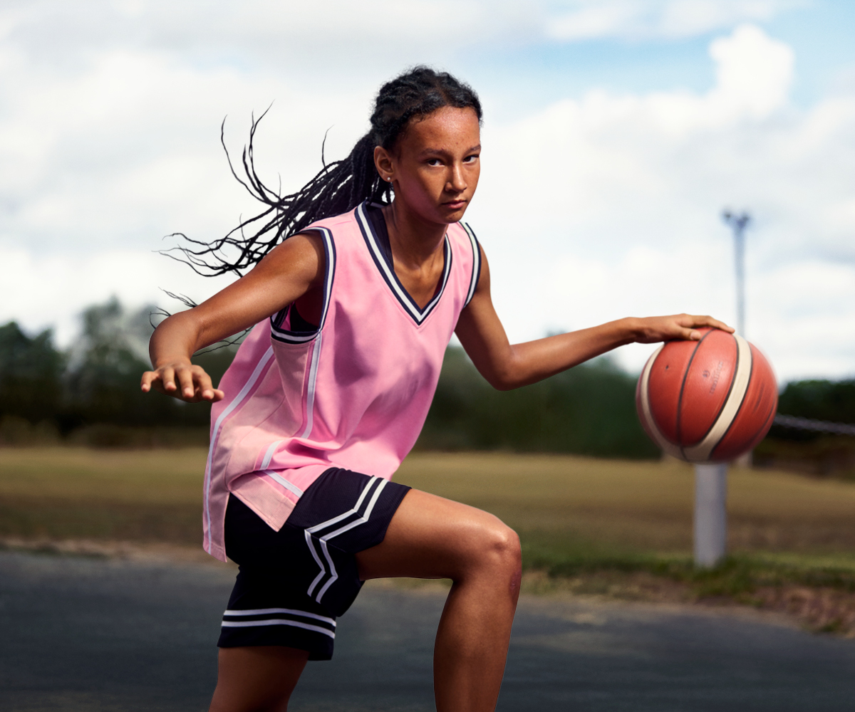 Image of a girl dribbling a basketball