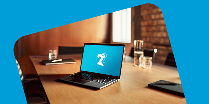 Image of a laptop with the 2degrees logo on the screen sitting on a desk