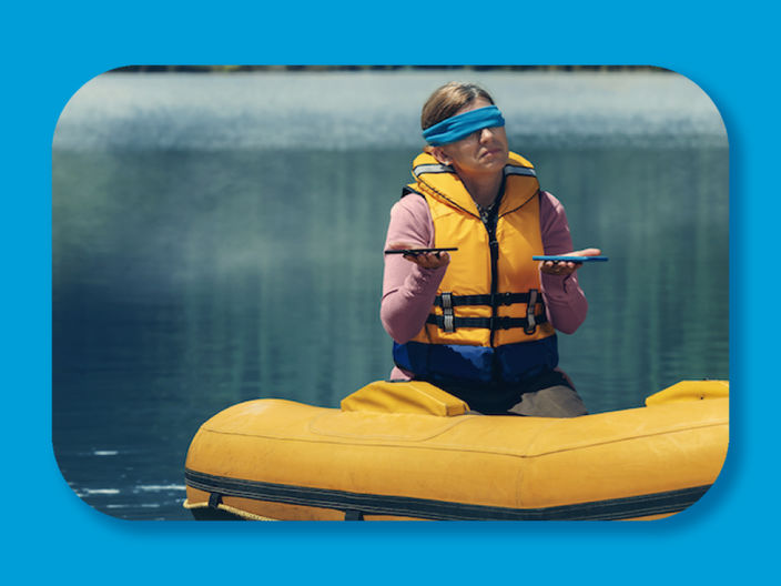 photo of a blindfolded woman in a inflatable boat holding two phones